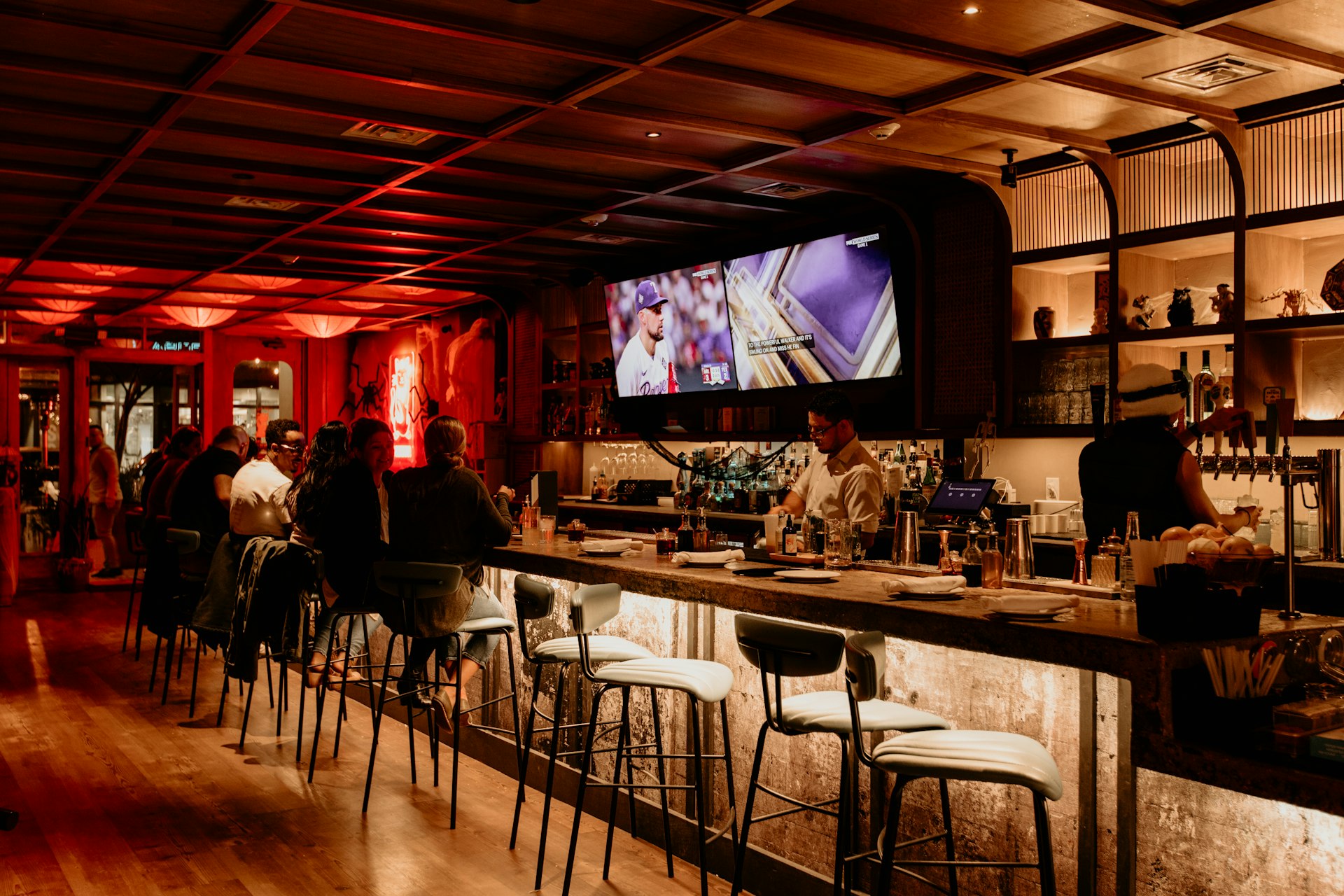 Bar with TVs showing sports and a point-of-sale terminal